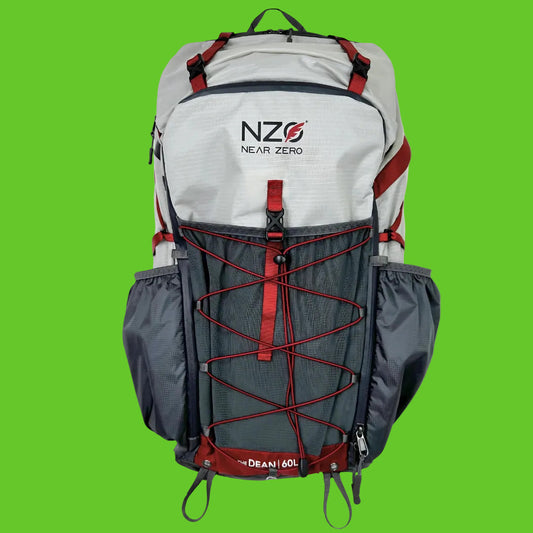 Gray and red backpack with 'NZ0 Near Zero' branding on a white background