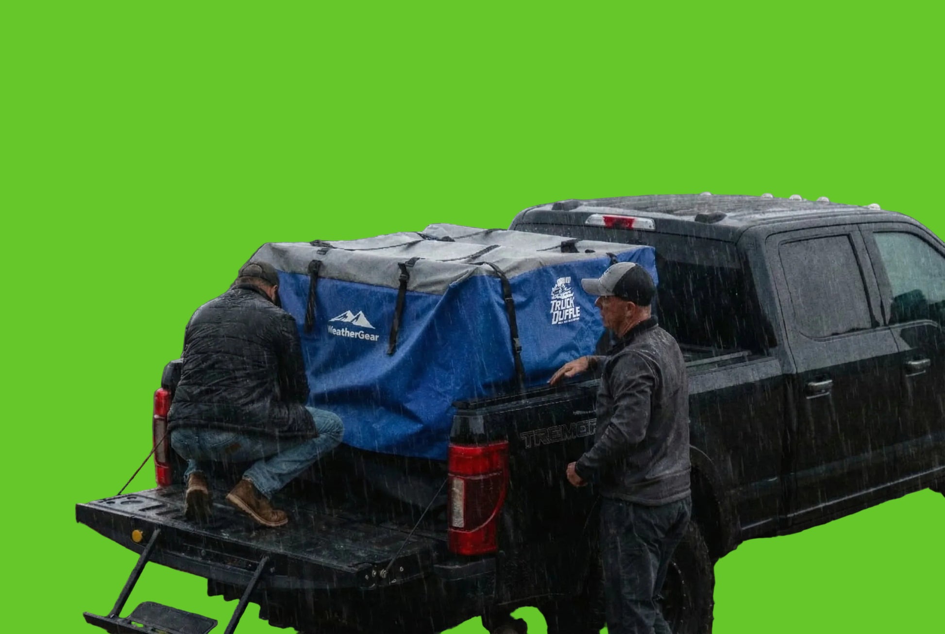 Two people setting up a blue rooftop tent on a truck in a forested area.