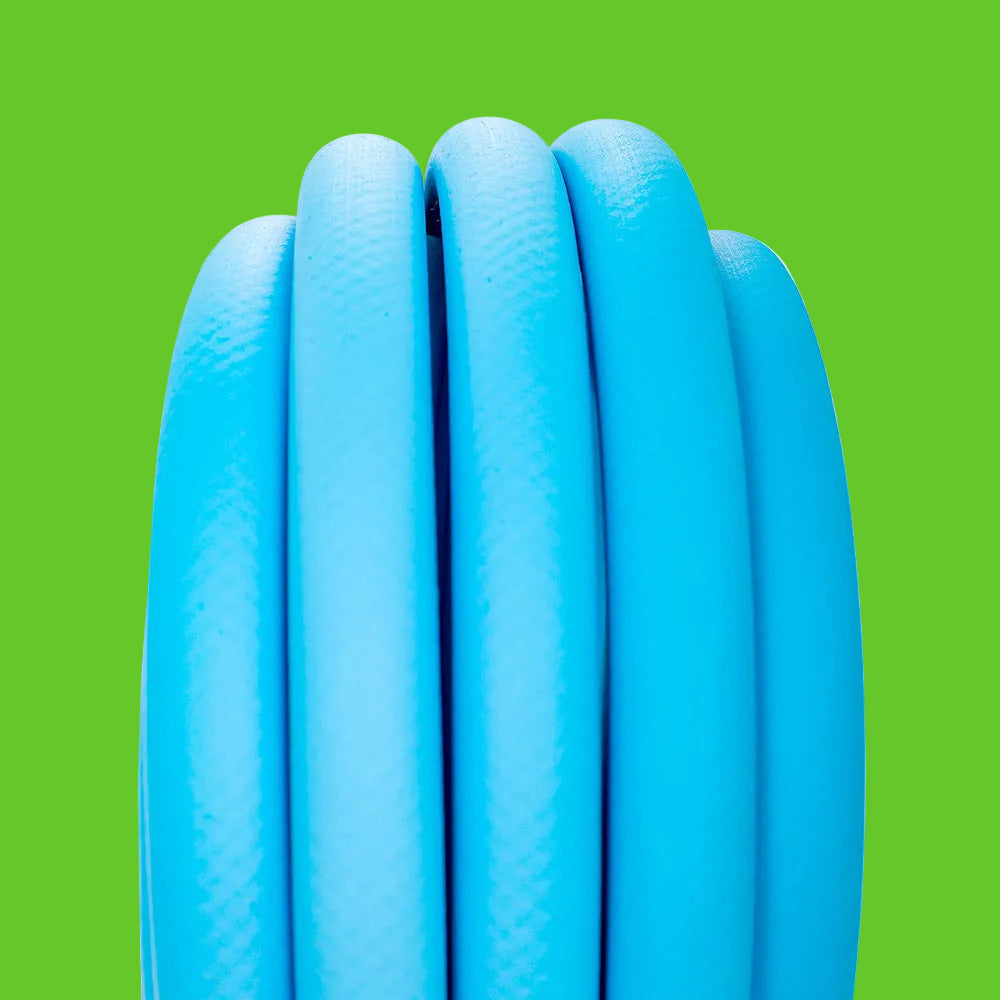 Close-up of a coiled blue pool hose on a white background