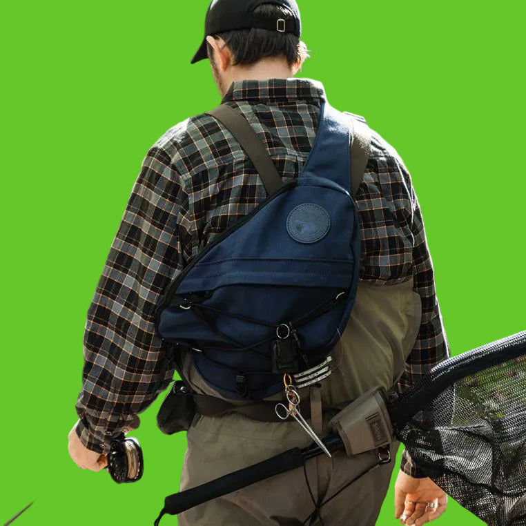 Person wearing a blue backpack in a forest setting