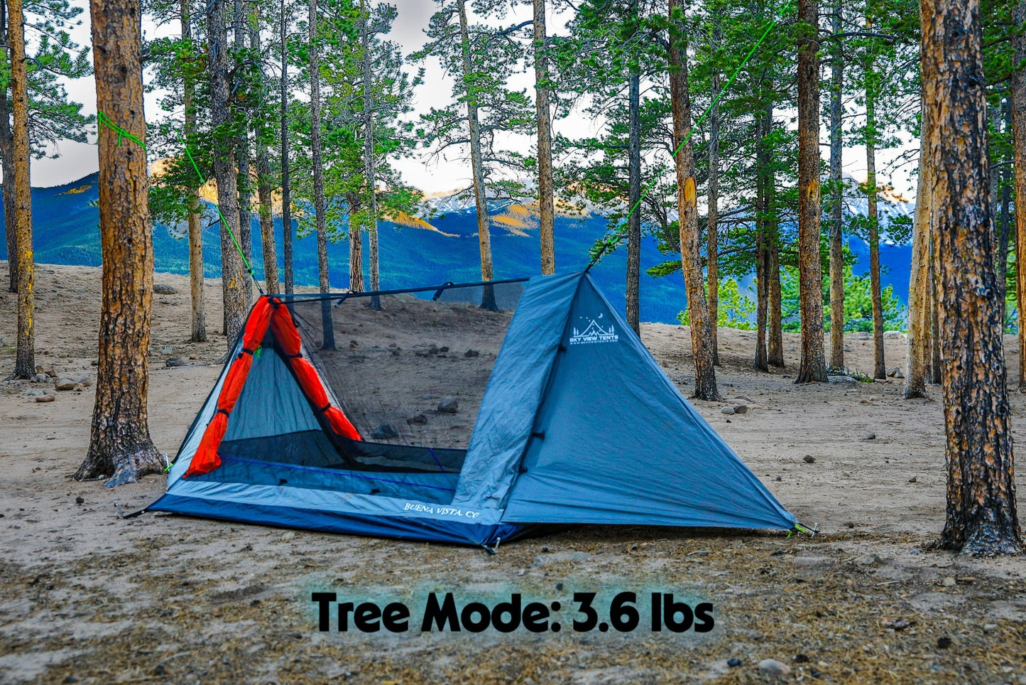Blue camping tent with red interior in a forest setting, labeled 'Tree Mode: 3.6 lbs'.