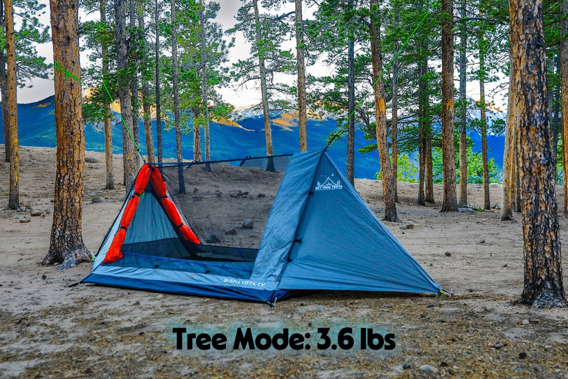 Blue camping tent with red interior in a forest setting, labeled 'Tree Mode: 3.6 lbs'.