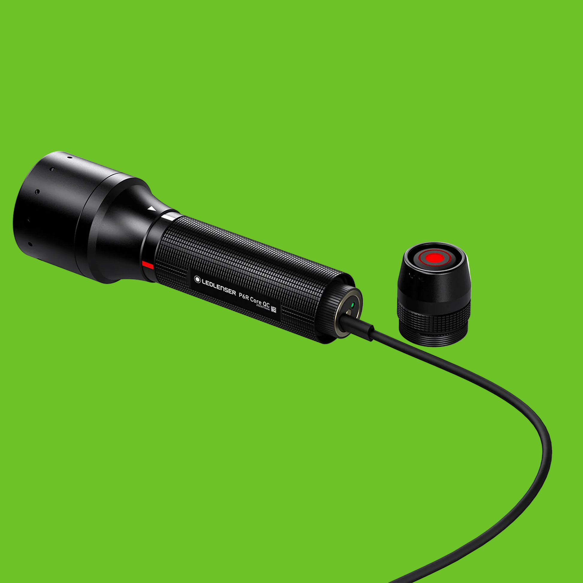 Black flashlight with a red light on a white background