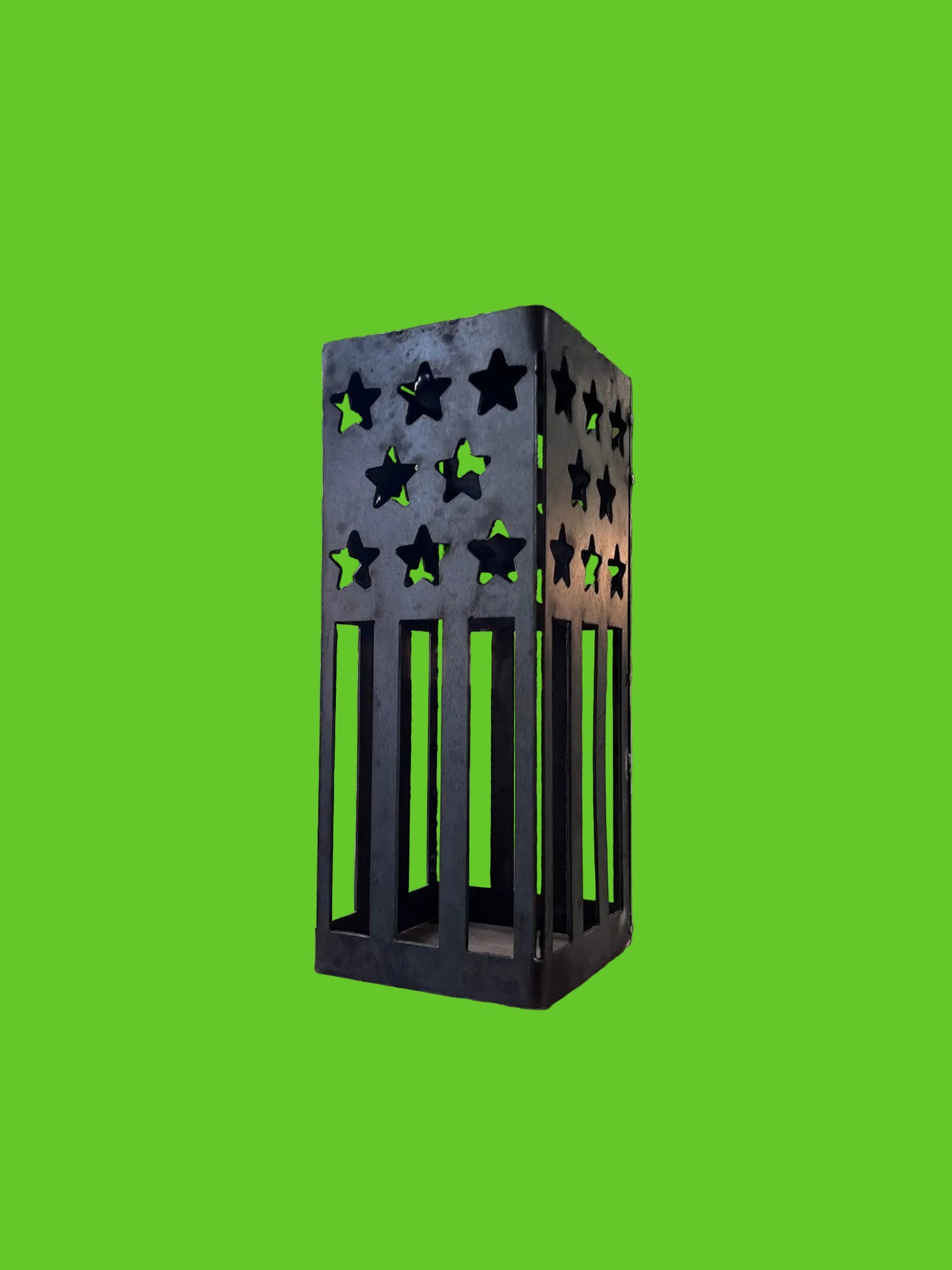 Black metal star-patterned lantern on a wooden surface with a scenic background