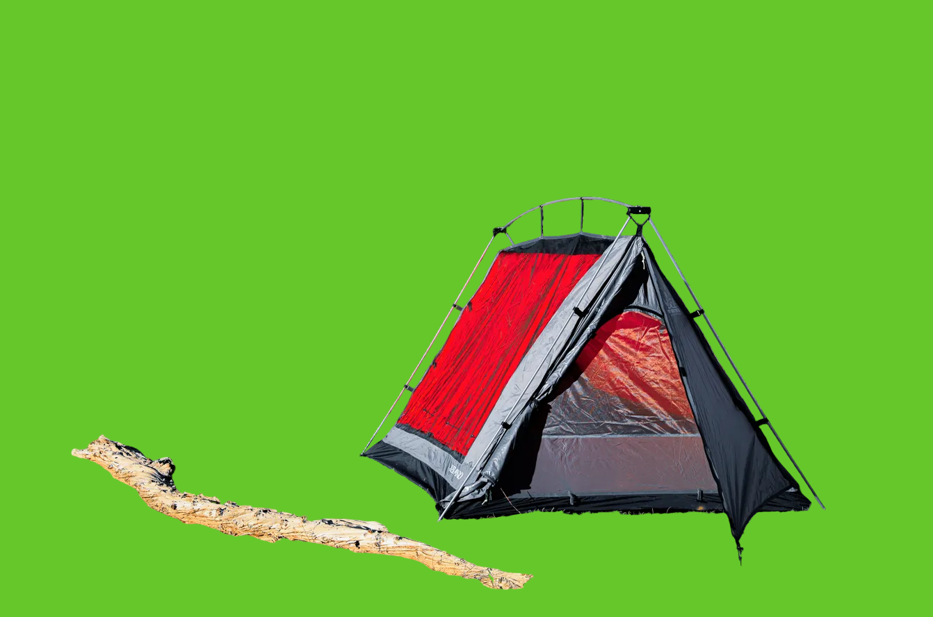 Red and gray tent set up in a desert landscape with rocky hills and sparse vegetation.