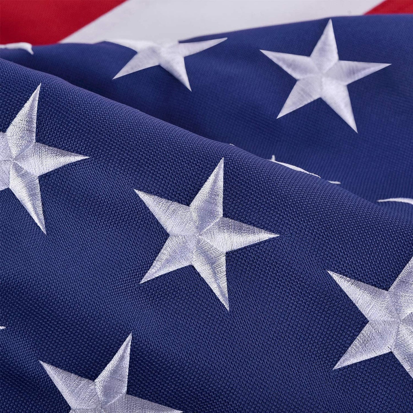 Close-up of American flag with stars and red and white stripes.