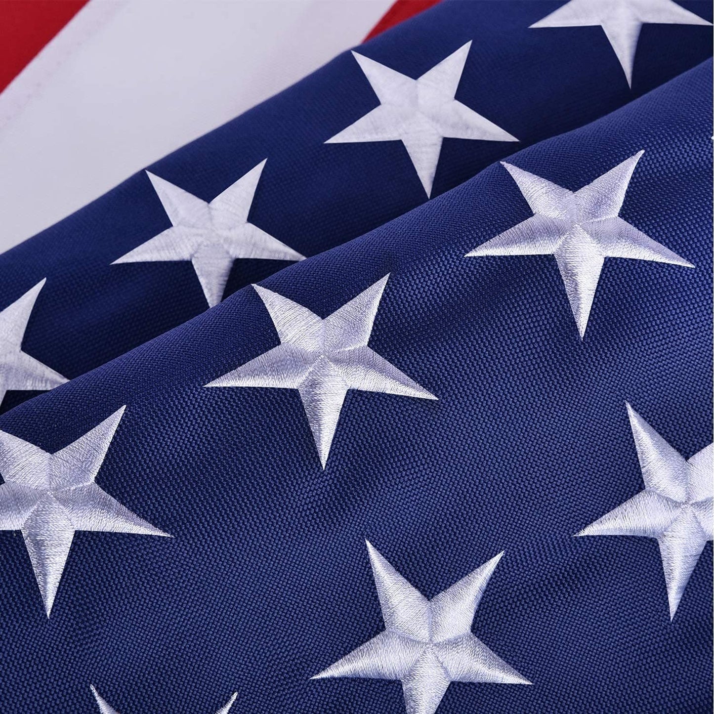 Close-up of American flag with white stars on blue background