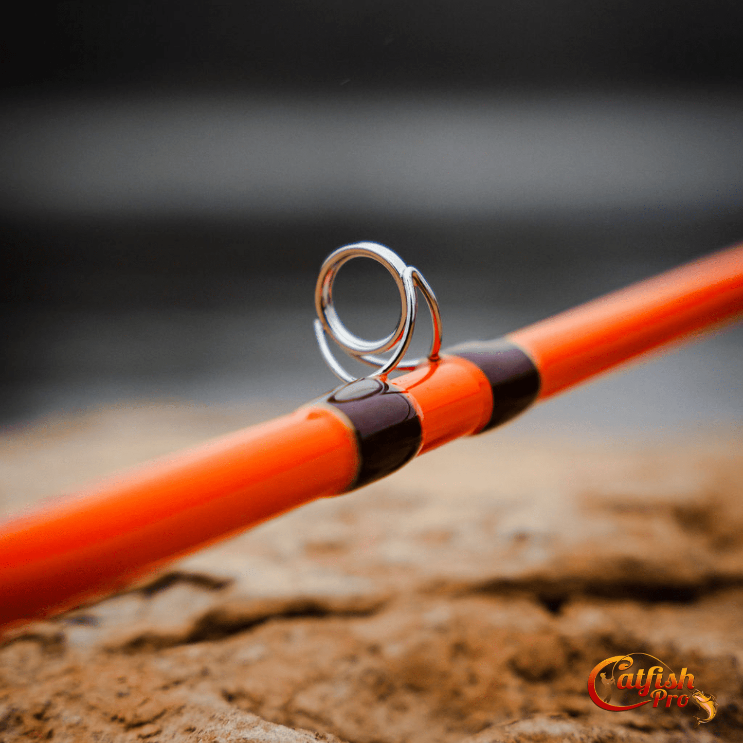 Close-up of a fishing rod with a hook on a blurred natural background