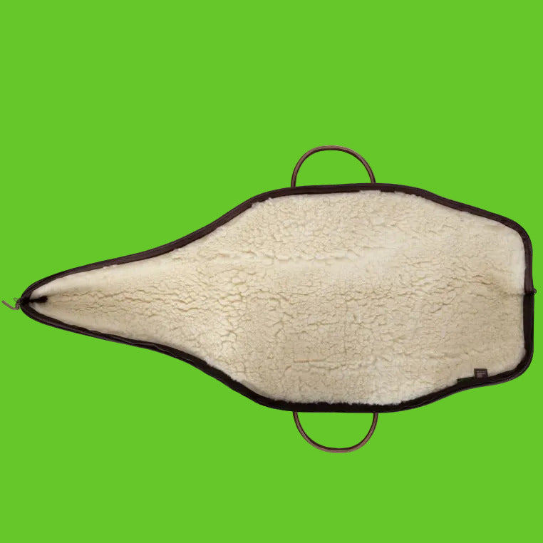 Sheepskin saddle pad with brown leather trim on a white background