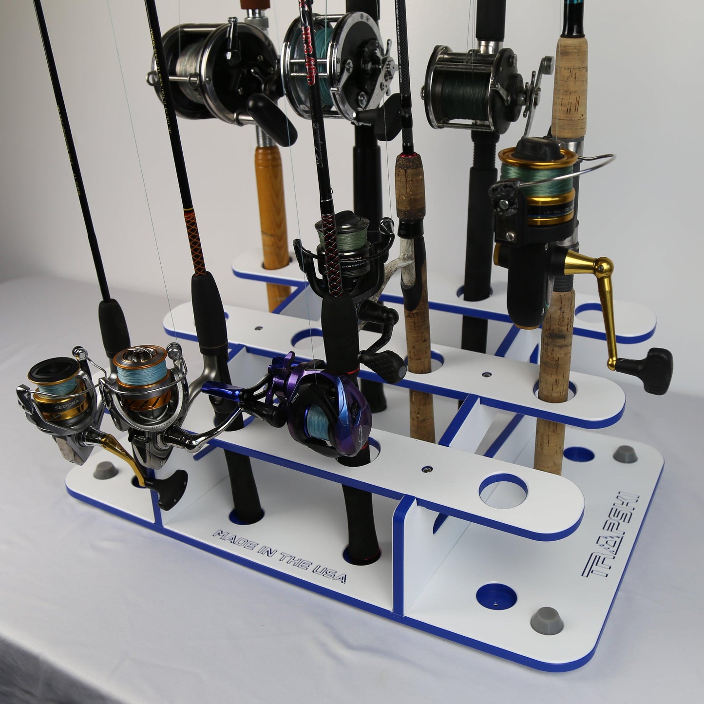 Fishing rod and reel holder with multiple fishing rods on a white background