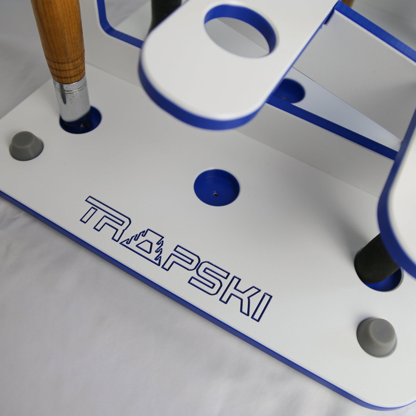 Close-up of a TRAPSKI branded metal tool with blue accents on a white background