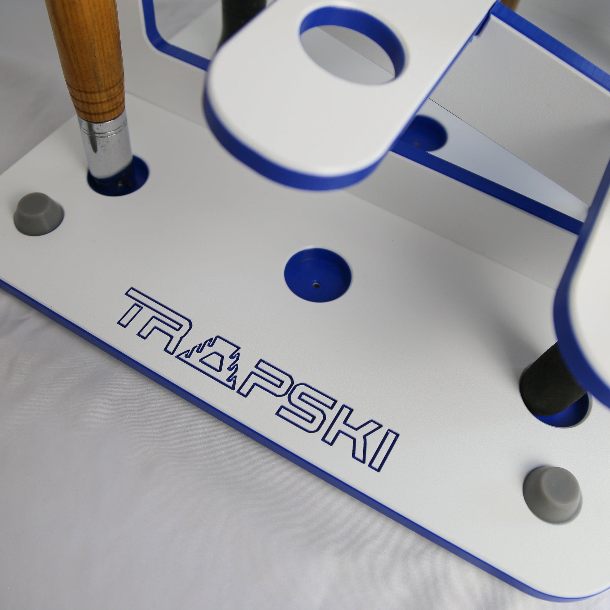 Close-up of a TRAPSKI branded metal tool with blue accents on a white background