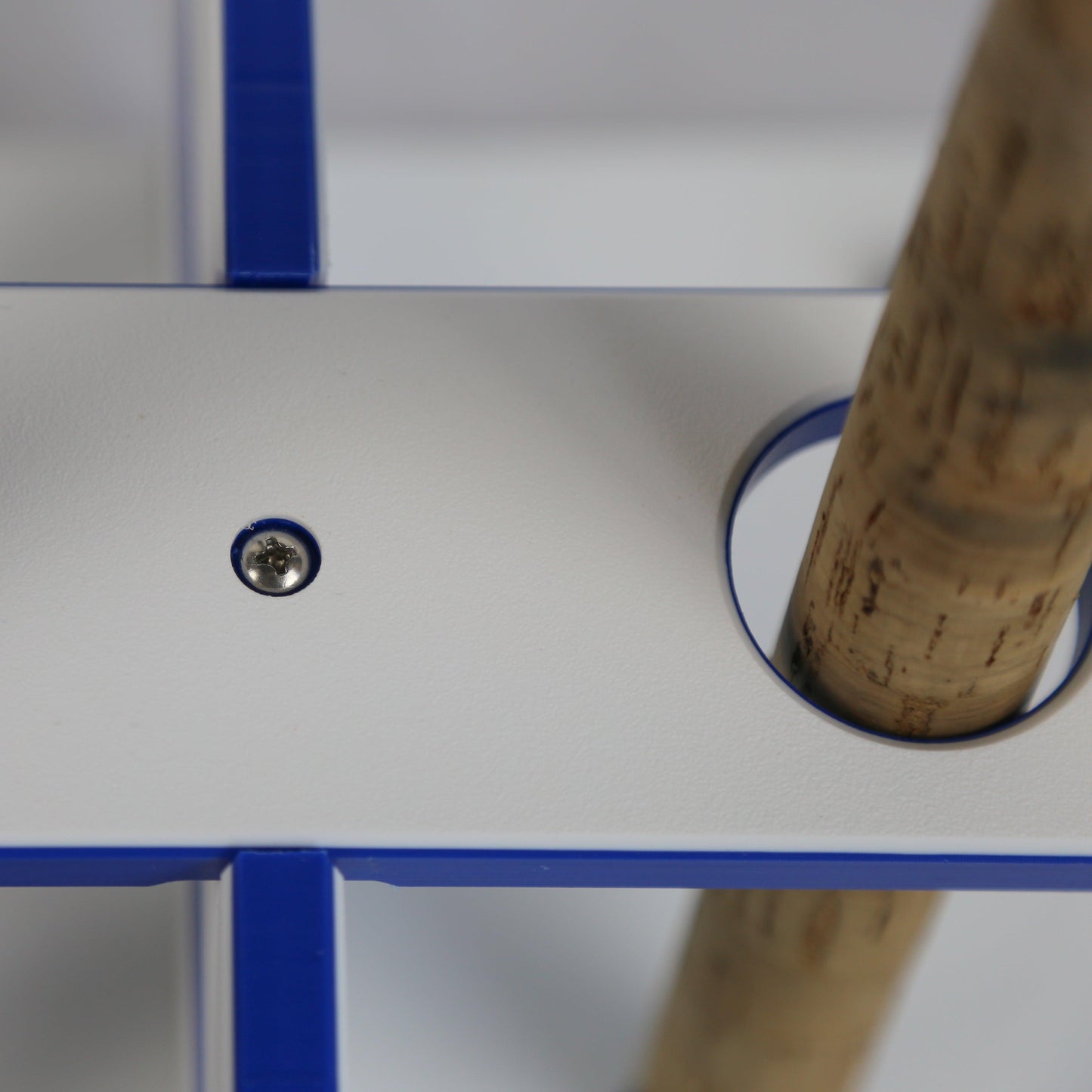 Close-up of a hockey stick with a cork tip on a white and blue background