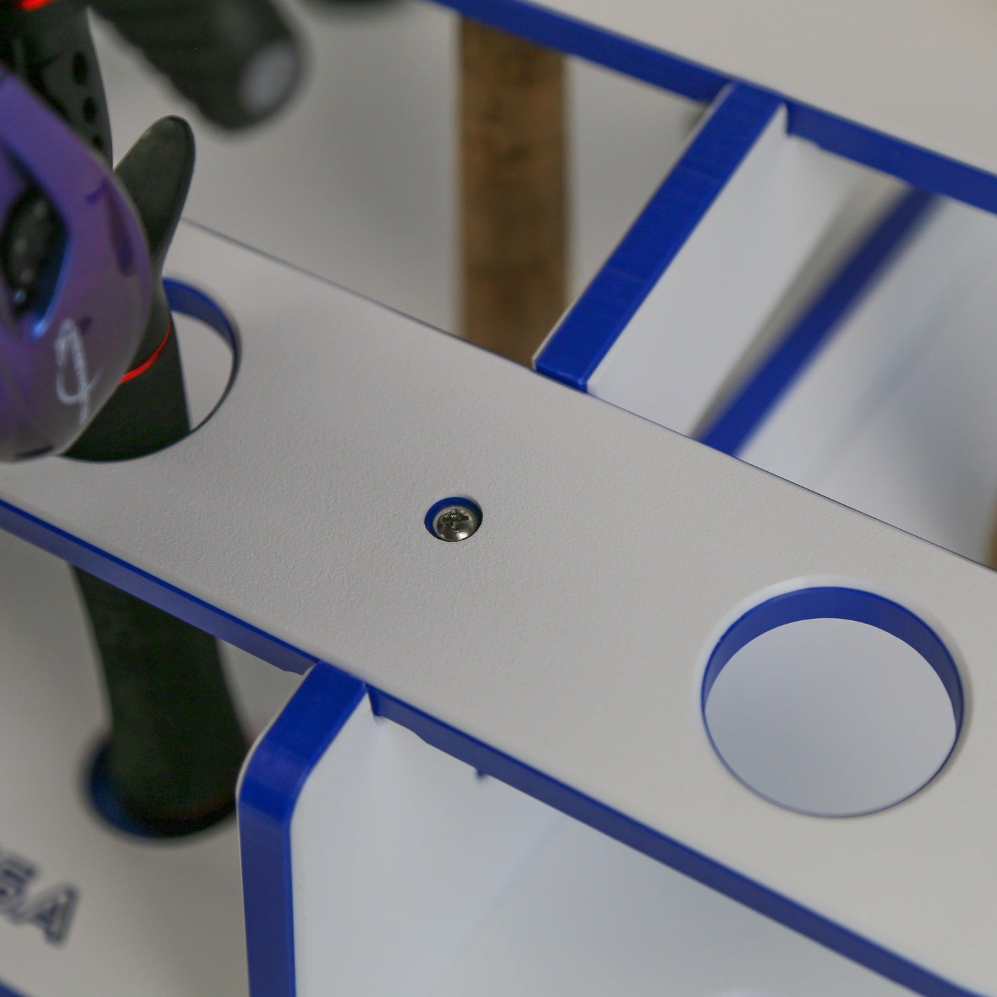 Close-up of a white and blue mechanical device with a circular component.