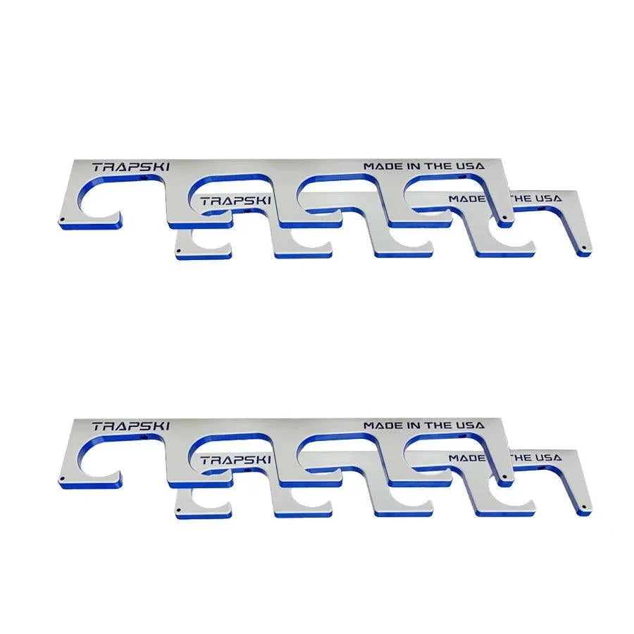 Two silver metal car frame trim guards with blue accents and black 'TRAPSKI' branding, displayed on a clean white background.