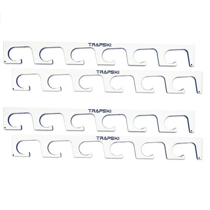 Four white plastic carpet trap strips with blue outline details and the brand name 'TRAPSKI' printed in black, arranged vertically on a white background.