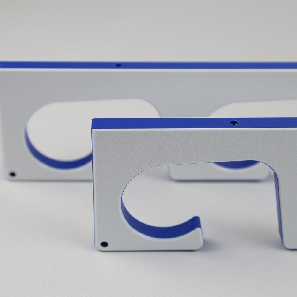 Metallic rectangular objects with blue accents on a gray background