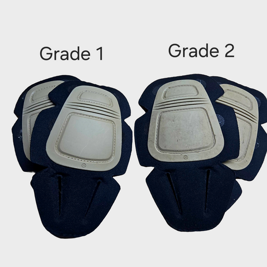 Two pairs of knee pads labeled 'Grade 1' and 'Grade 2' on a white background.