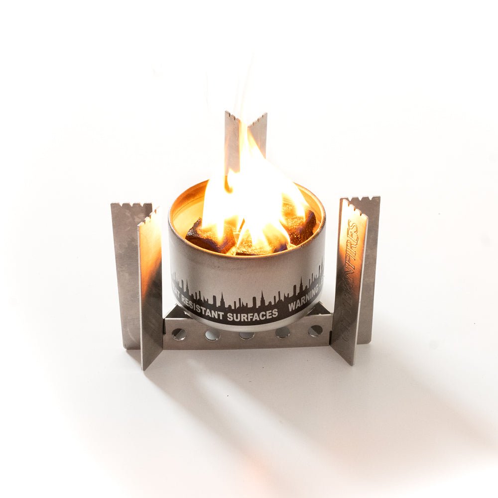 Small metal fire pit with flames on a white background