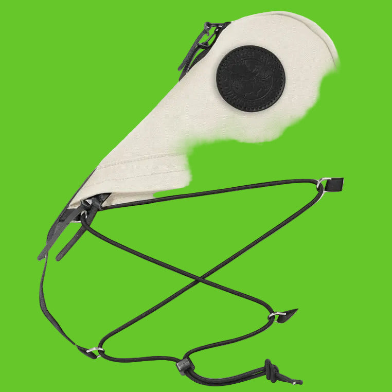 Beige bag with black straps on a white background