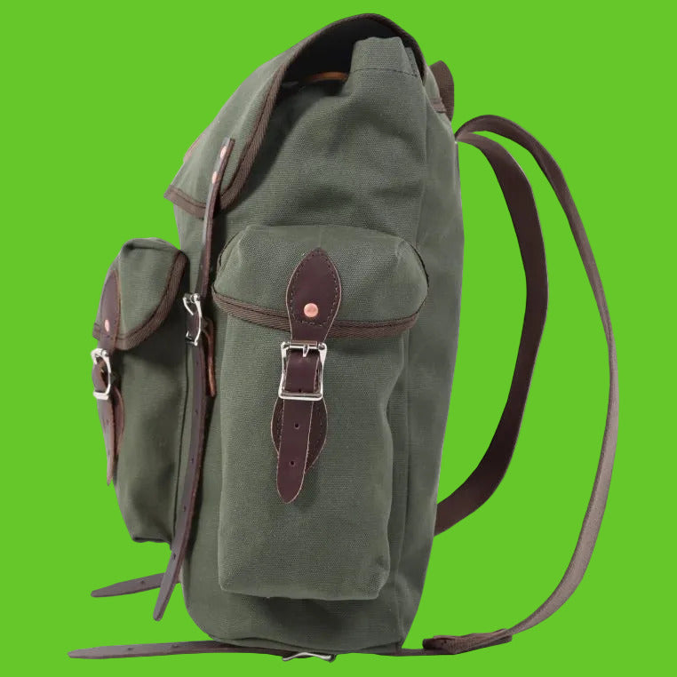Green backpack with brown leather straps on a white background