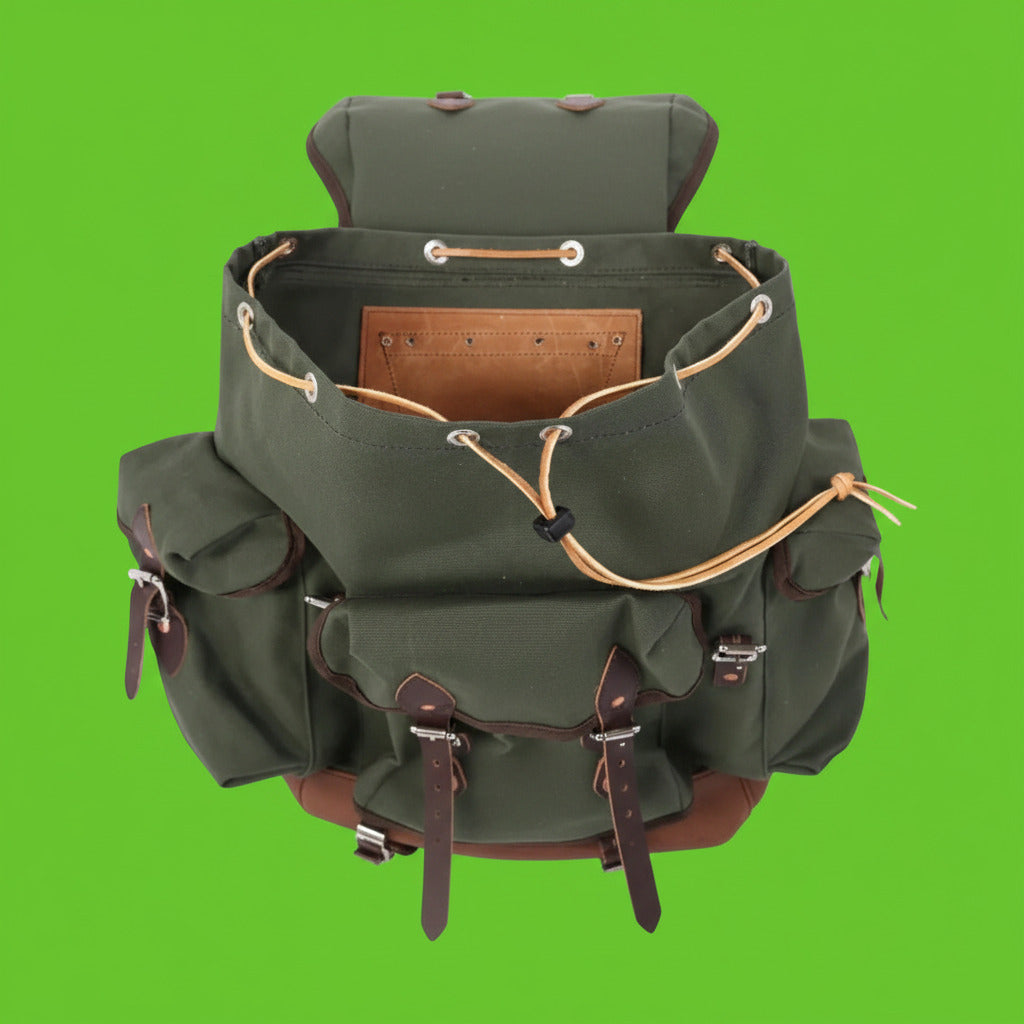 Green backpack with brown leather straps on a white background